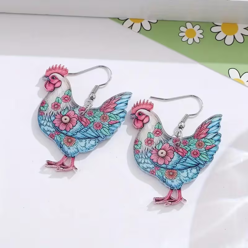 Chicken-shaped pendant earrings featuring soft blue feathers